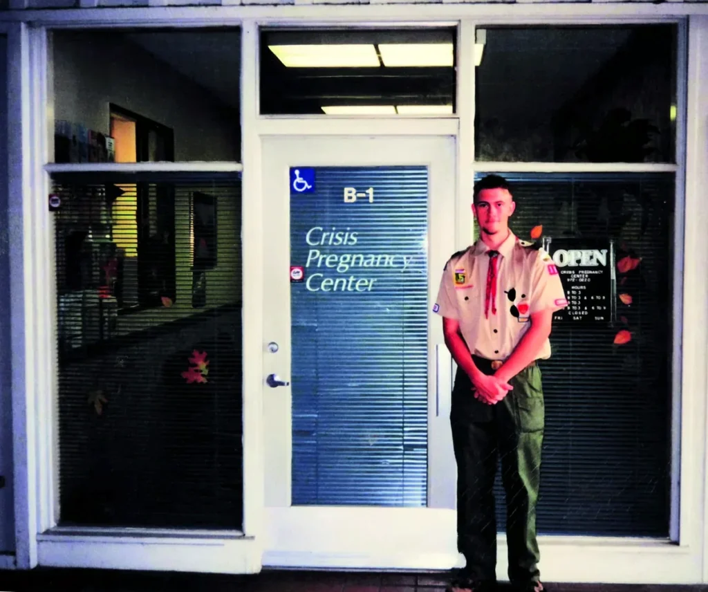Jonathan Keller at eighteen in his Scout uniform outside the Sacramento-area pregnancy resource center he served for his Eagle Scout project, October 2000