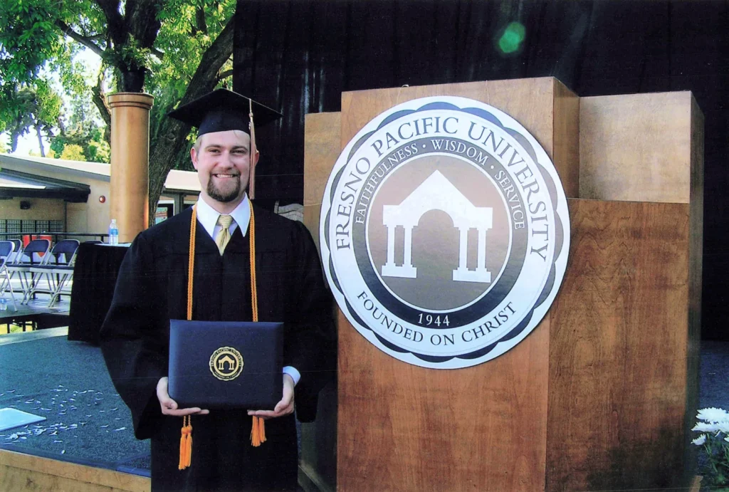 Jonathan Keller in cap and gown with his diploma at Fresno Pacific University in 2009.