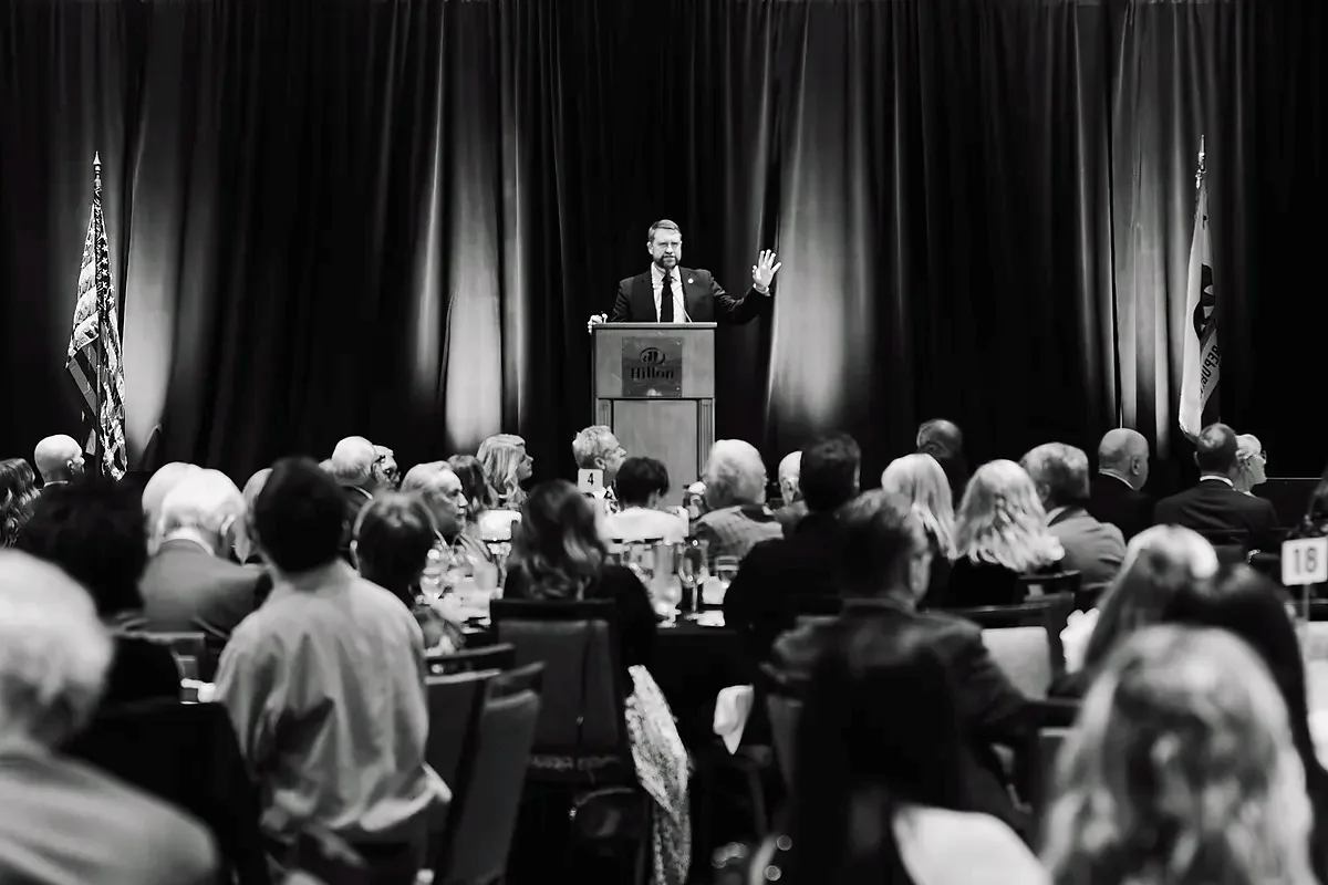 Jonathan Keller speaking to a full ballroom at the 2023 gala