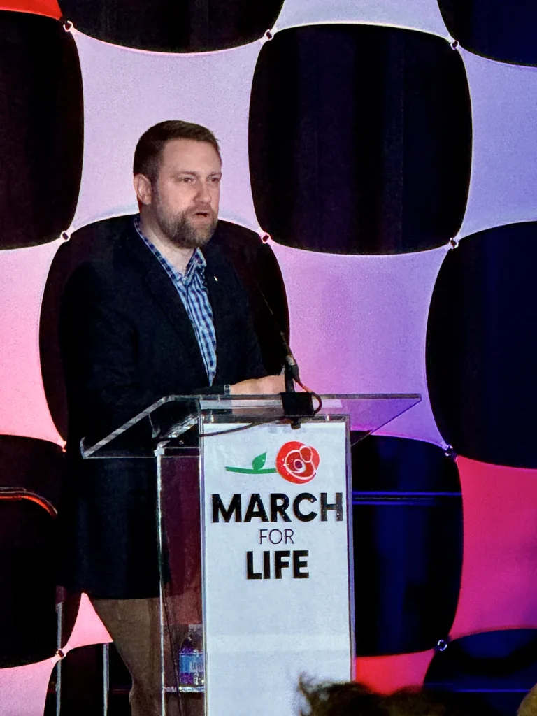 Jonathan Keller speaks at a March for Life podium in 2024.